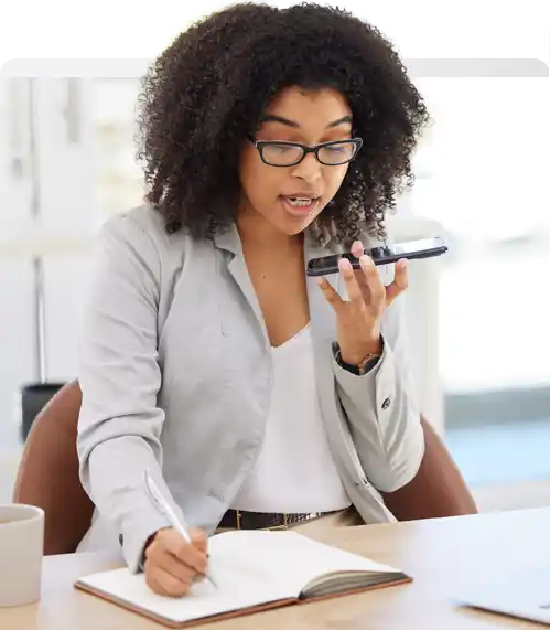 Assistant on a phone call taking notes